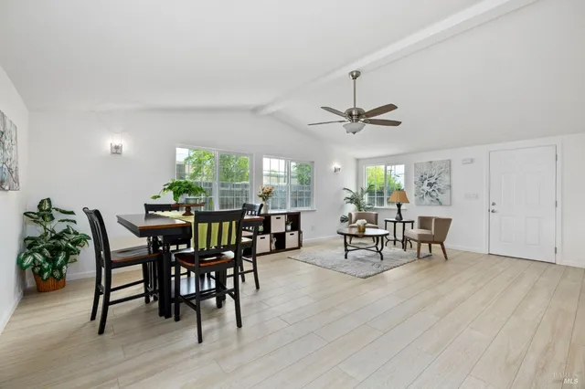 a kitchen with kitchen island wooden floors appliances and sink