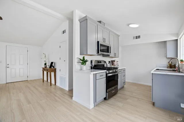 a kitchen with a stove a sink and a refrigerator