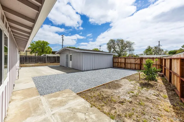 a view of a backyard with sitting area