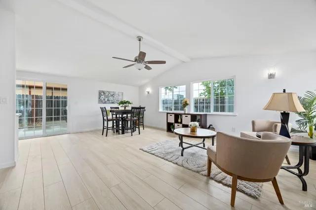 a living room with furniture a window and a table