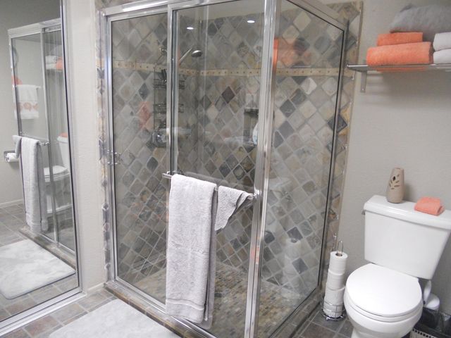 a white toilet next to a bathroom