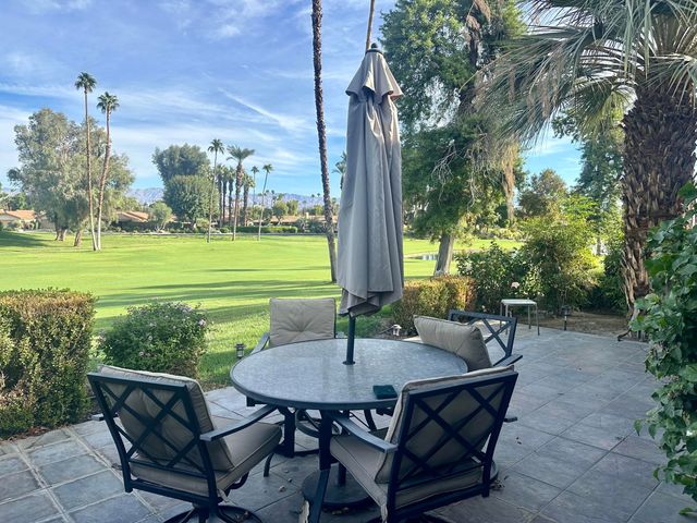 a view of a patio with table and chairs and potted plants