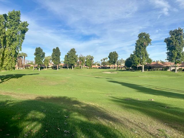 a yard with lots of green space and trees