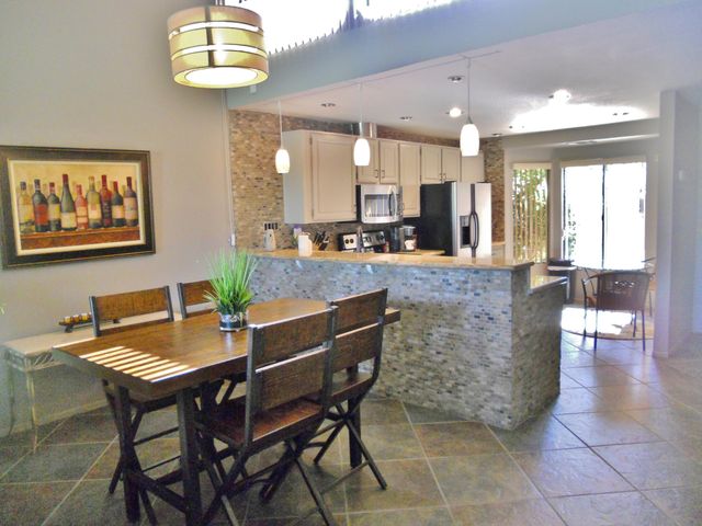 a view of a dining room with furniture and a chandelier