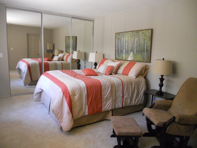 a bed room with a bed window and a chair