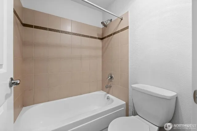 a bathroom with a toilet and a bathtub
