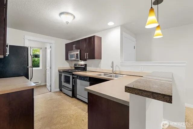 a kitchen with a stove a sink and a refrigerator