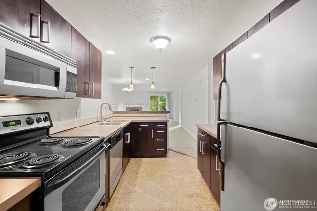 a kitchen with stainless steel appliances a stove and a refrigerator
