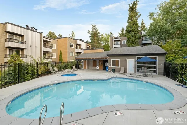 a view of house with swimming pool outdoor seating