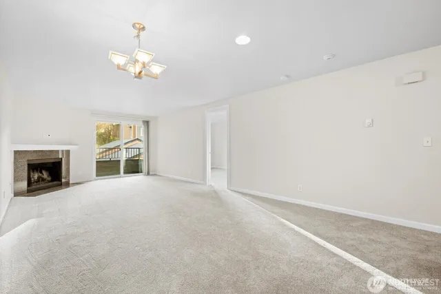 a view of an empty room with a fireplace