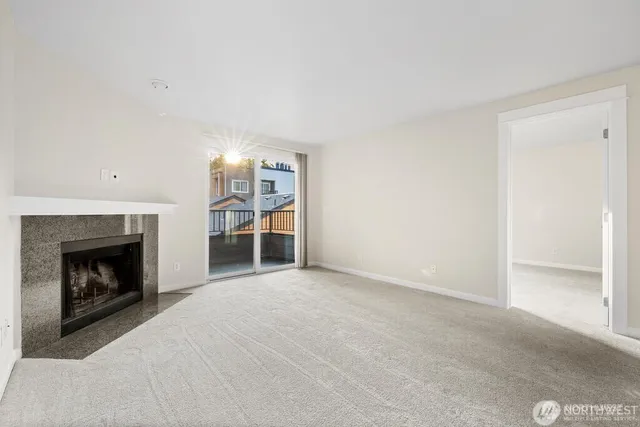 a view of empty room with a fireplace