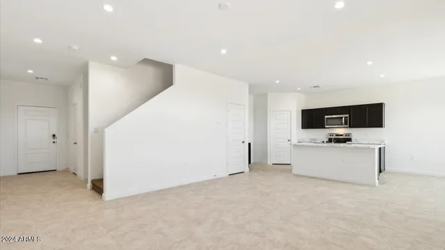 a view of a kitchen with a sink and a refrigerator