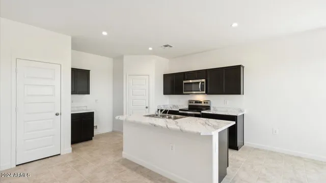 a kitchen with stainless steel appliances a sink and a microwave