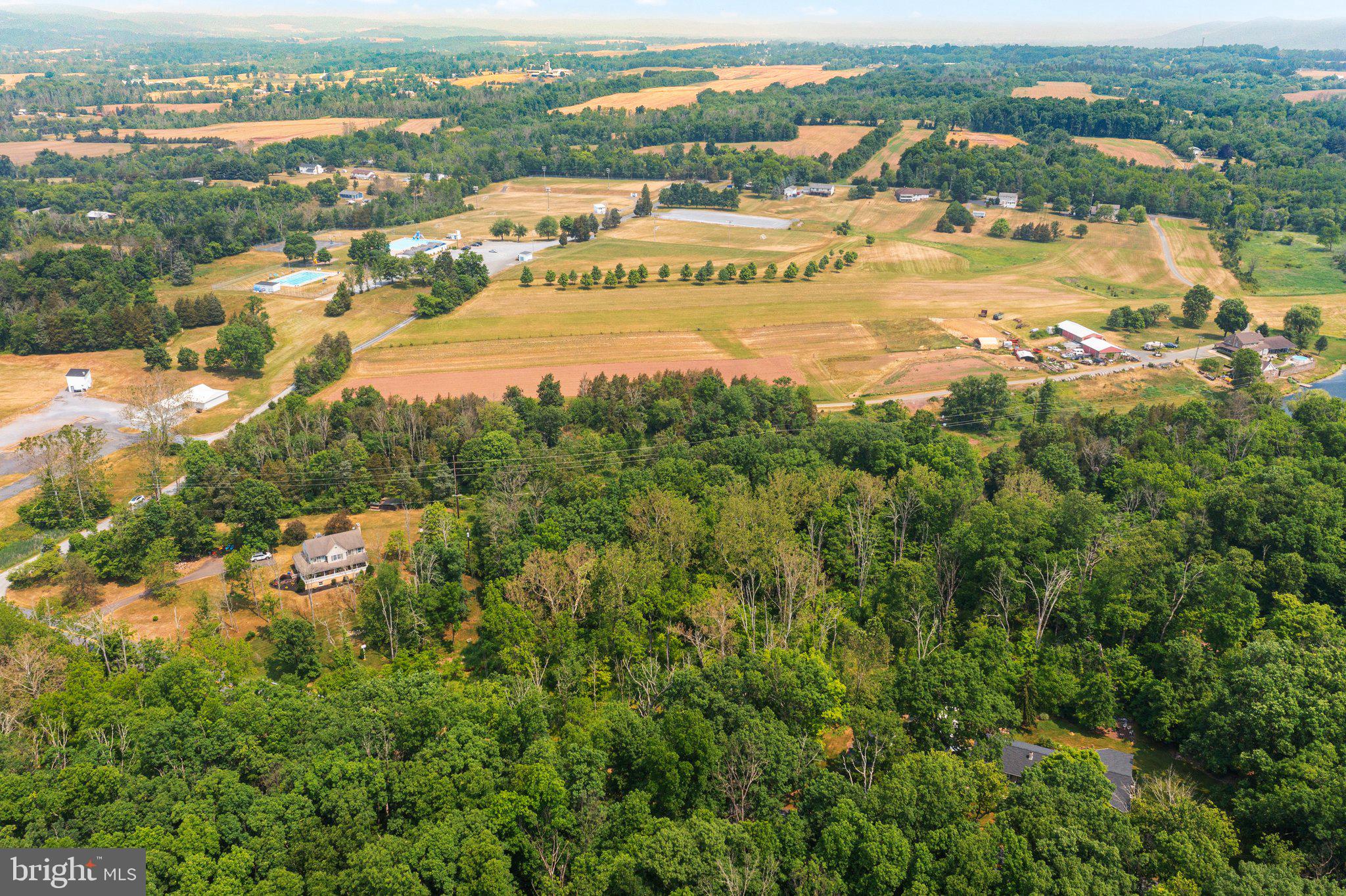 581 Monocacy Hill Road Birdsboro, PA 19508 - Photo 4 of 11 an aerial view of city and lake with trees all around