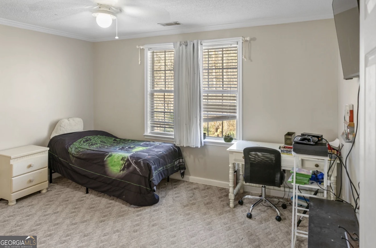 4430 Oak Hill Church Road Millen, GA 30442 - Photo 27 of 41 a bedroom with a bed and a desk