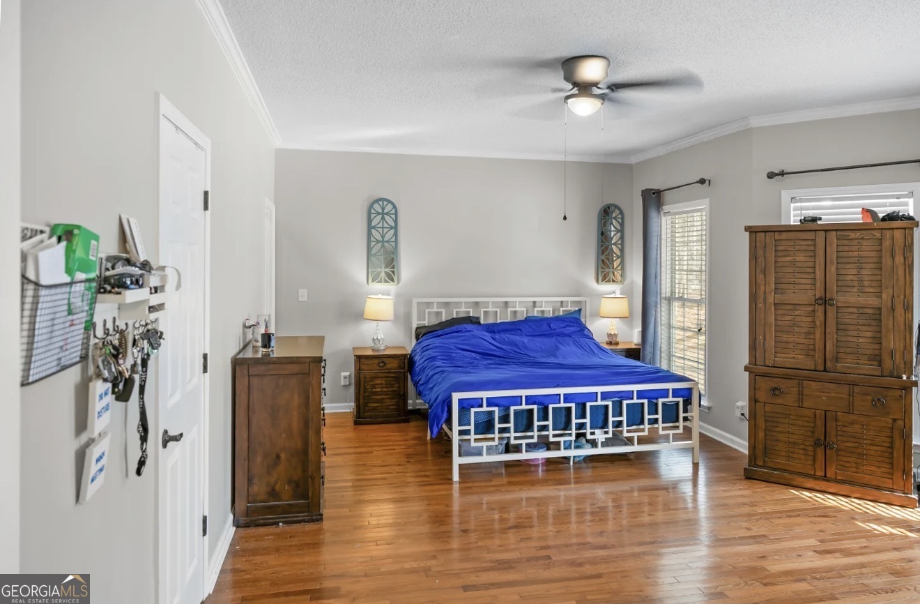4430 Oak Hill Church Road Millen, GA 30442 - Photo 33 of 41 a living room with furniture a wooden floor and a chandelier