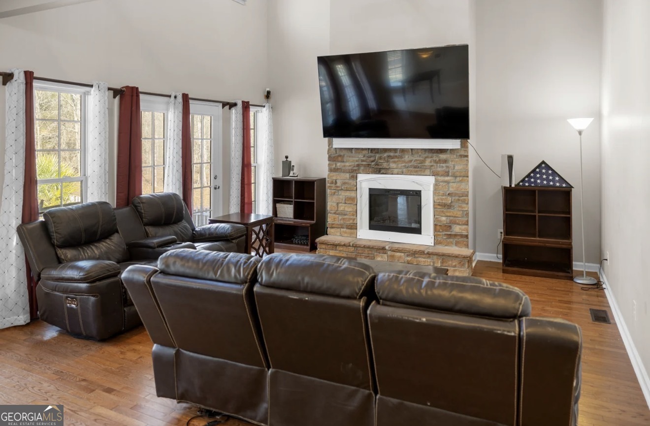 4430 Oak Hill Church Road Millen, GA 30442 - Photo 39 of 41 a living room with furniture a flat screen tv and a fireplace