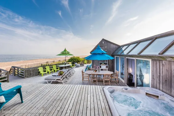 a view of a patio with couches table and chairs with wooden floor and fence