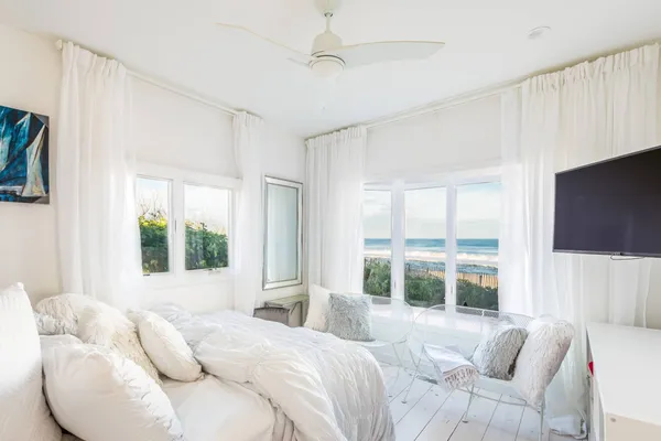 a bedroom with a bed and a large window