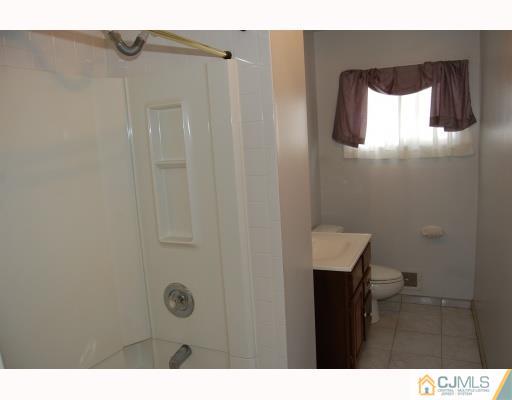 91 Princeton Road Old Bridge, NJ 08859 - Photo 3 of 9 a bathroom with a sink and mirror