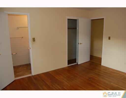 91 Princeton Road Old Bridge, NJ 08859 - Photo 5 of 9 a view of an empty room with wooden floor