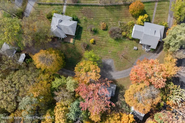 an aerial view of a house with a yard