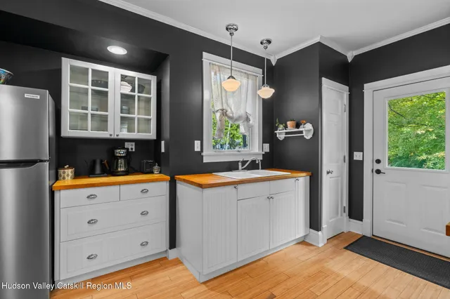 a kitchen with stainless steel appliances granite countertop a sink a stove and a refrigerator