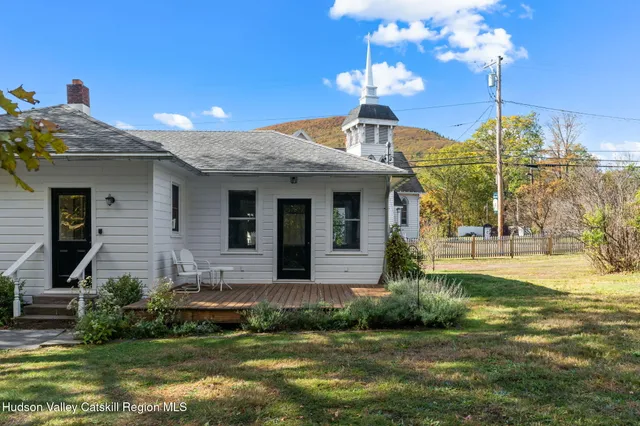 a backyard of a house with outdoor seating