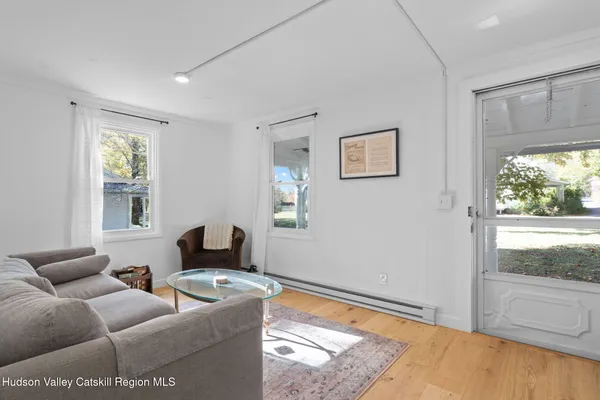 a kitchen with stainless steel appliances granite countertop a stove top oven a sink a dining table and chairs