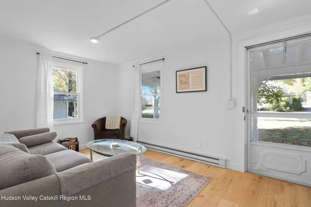 a kitchen with stainless steel appliances granite countertop a stove top oven a sink a dining table and chairs