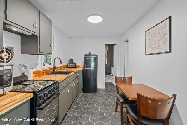 a bedroom with a bed lamp and a window