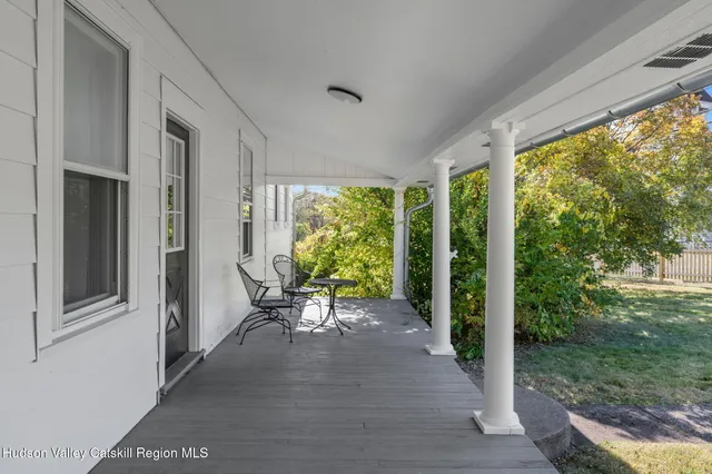 a view of a porch with chairs and backyard