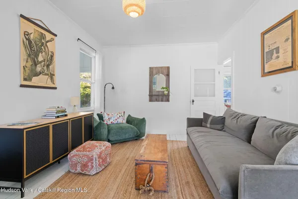 a living room with furniture and painting on the wall