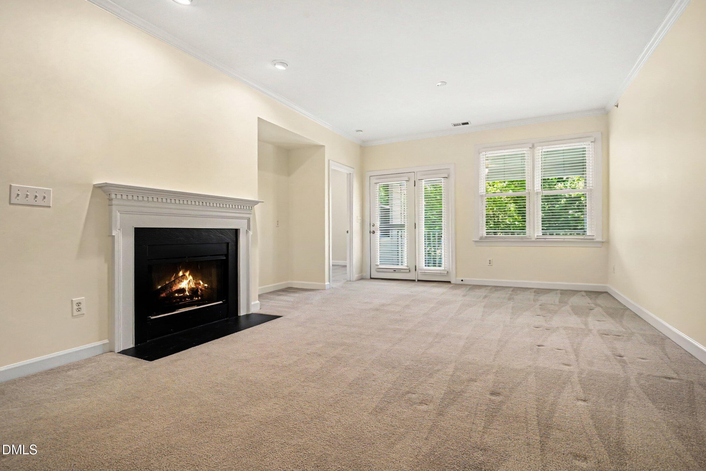 2651 Mellowfield Drive, Unit 203 Raleigh, NC 27604 - Photo 2 of 32 a view of an empty room with a window and fireplace