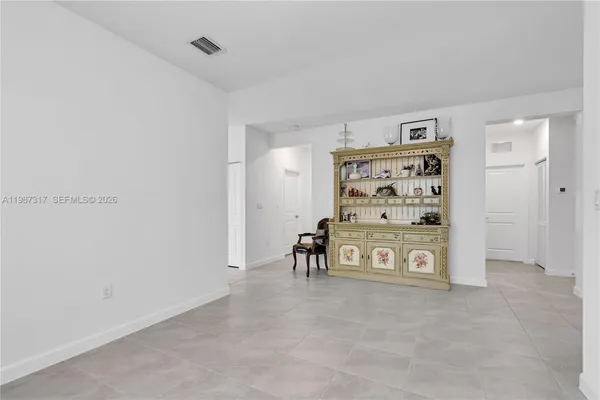 a large kitchen with kitchen island a large counter top space a sink stainless steel appliances and cabinets