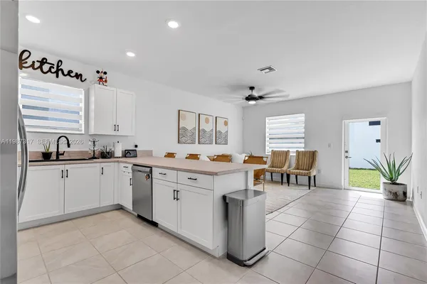 a living room with furniture and kitchen view