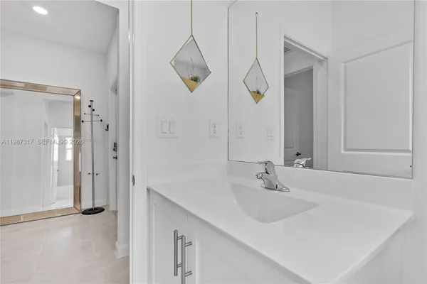 a bathroom with a sink and mirror