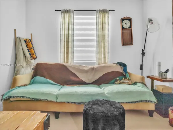 a bedroom with a bed and wooden cabinets