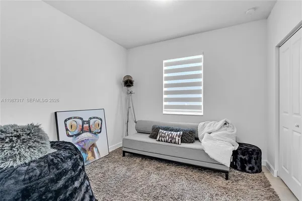 a bedroom with a bed and a couch