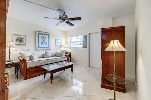 a living room with furniture a lamp and a window