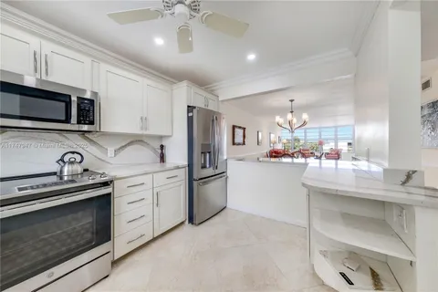 a kitchen with stainless steel appliances granite countertop a stove and cabinets