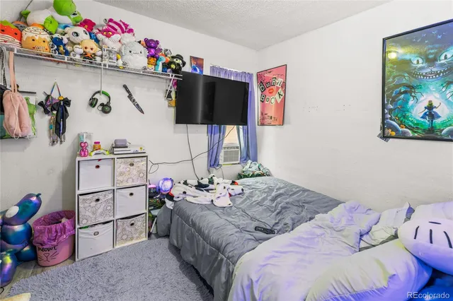 a bedroom with a bed a couch and dresser