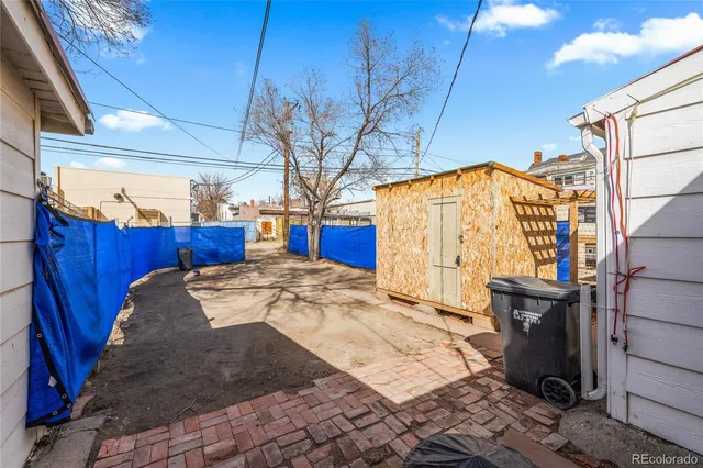 a view of a backyard with wooden fence