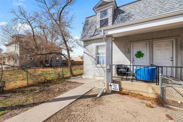 a view of a house with a yard covered in snow