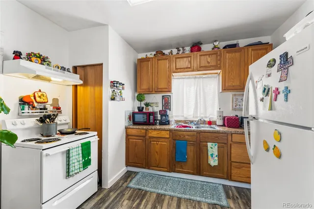 a kitchen with stainless steel appliances granite countertop a stove a refrigerator and a dining table