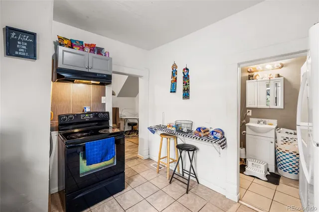 a kitchen with stainless steel appliances kitchen island granite countertop a stove and cabinets