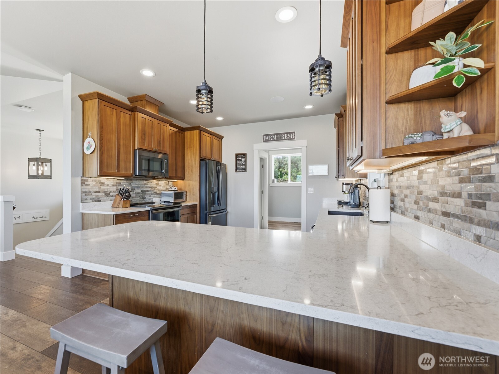 2128 McEldowney Road Malaga, WA 98828 - Photo 13 of 39 a large kitchen with kitchen island a large counter space a sink appliances and cabinets