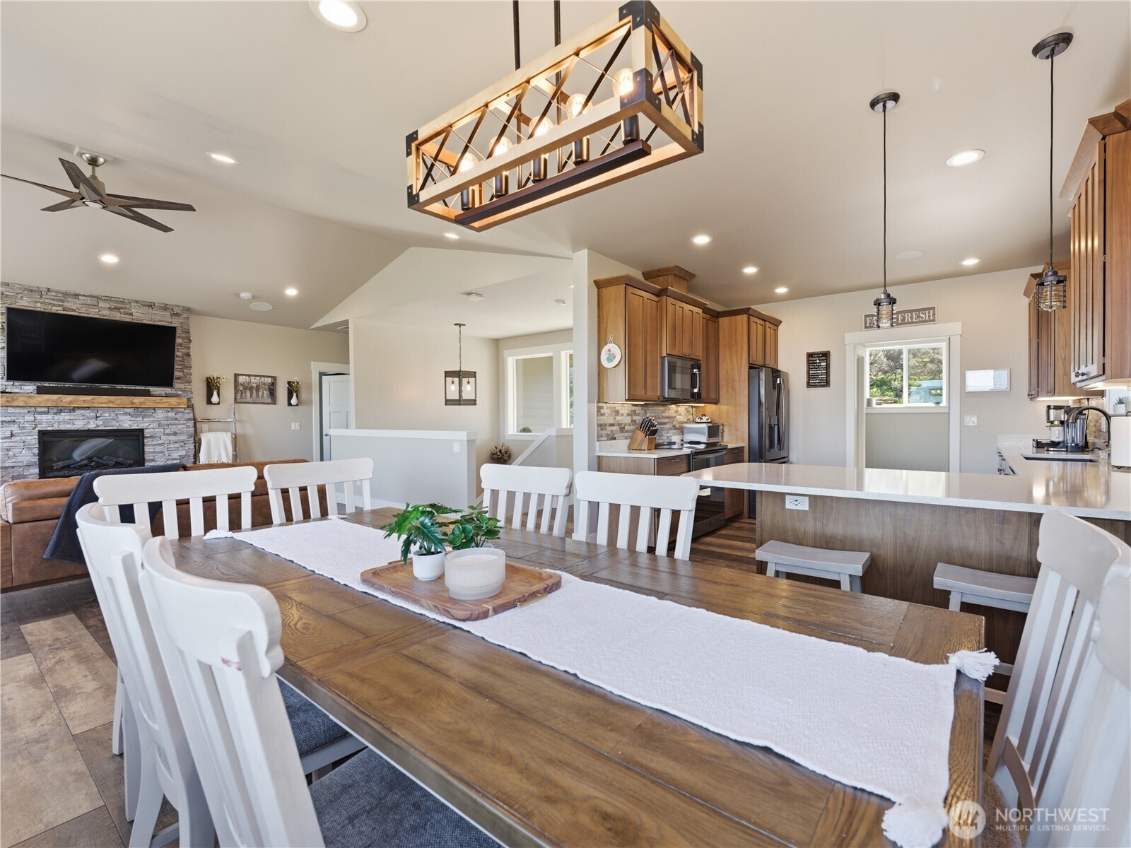 2128 McEldowney Road Malaga, WA 98828 - Photo 14 of 39 a view of a dining room and livingroom with furniture wooden floor a chandelier