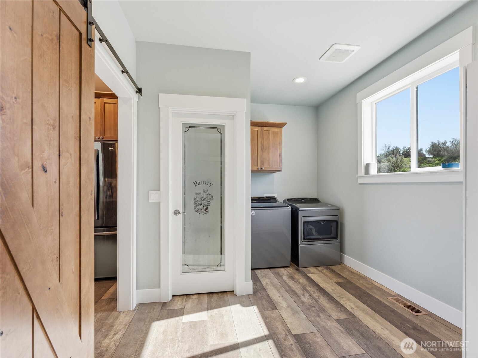 2128 McEldowney Road Malaga, WA 98828 - Photo 16 of 39 a view of a hallway with a bedroom and windows
