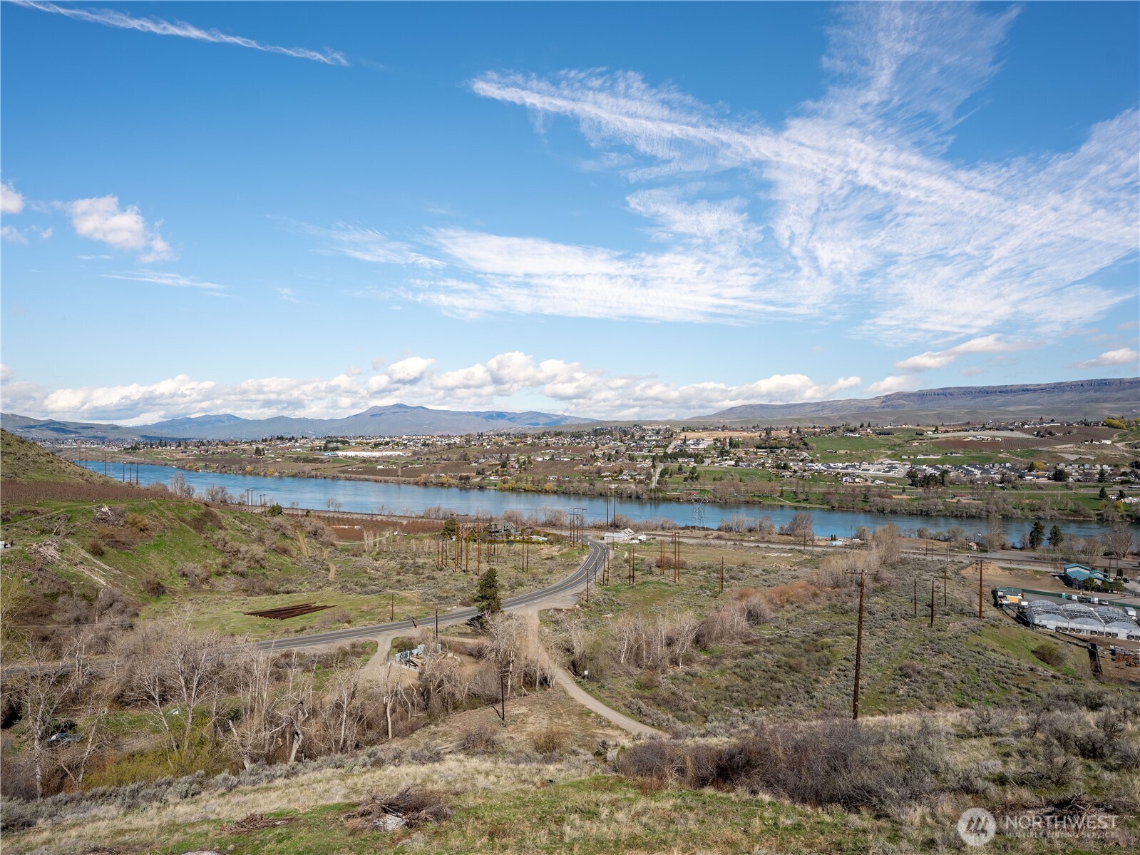 2128 McEldowney Road Malaga, WA 98828 - Photo 26 of 39 a view of a lake with mountain in the background